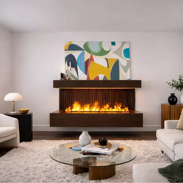 A modern living room with a floating fireplace, abstract art above the mantel, neutral furniture, a glass coffee table, and a shag rug.
