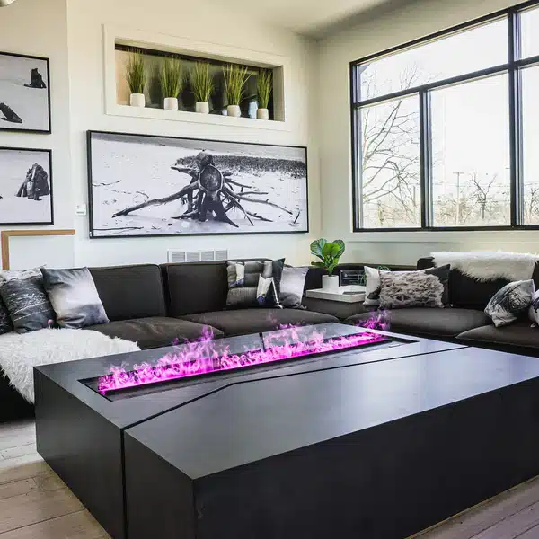 Modern living room with a sectional sofa, black-and-white decor, large windows, and a rectangular coffee table with a built-in fireplace emitting purple flames.