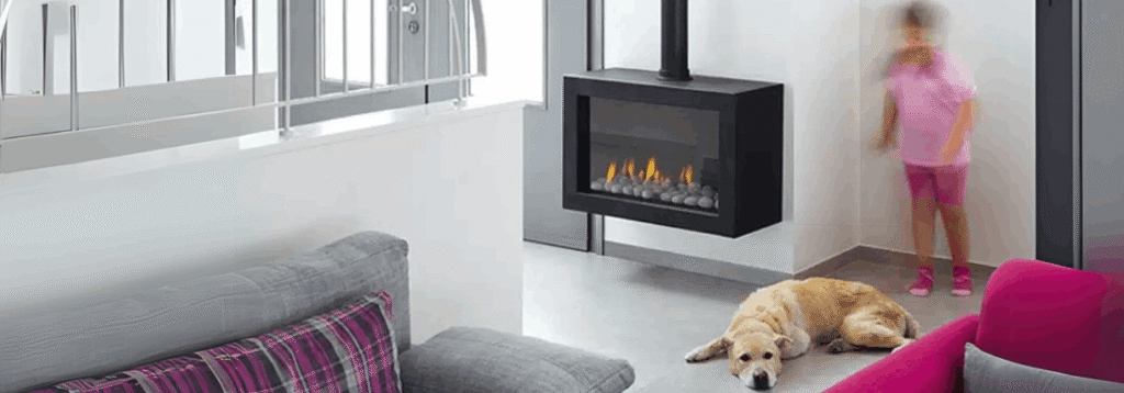 A dog lies on the floor near a modern built-in fireplace, while a child in pink stands in the background of a contemporary living room.